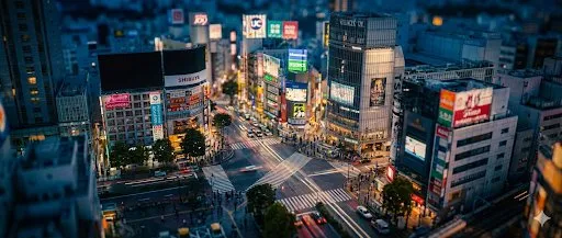 Tilt-shift miniature night view of city intersection, AI generated