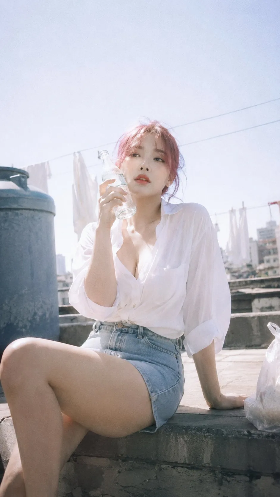 Pink-haired woman sitting on rooftop holding a water bottle, white blouse and denim skirt, natural light, AI generated