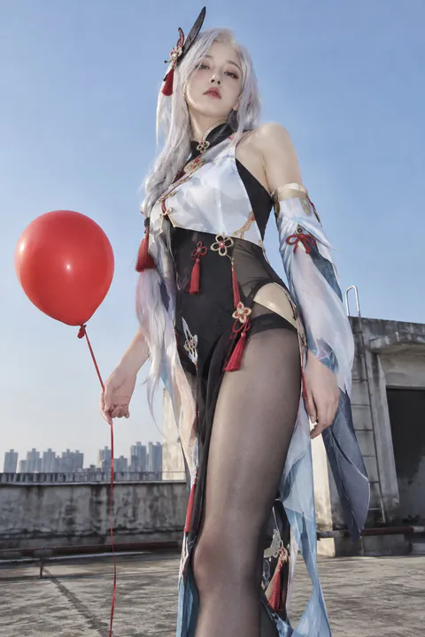 Low-angle shot of a silver-haired woman in a high-slit tailored dress holding a red balloon on an urban rooftop, generated wi