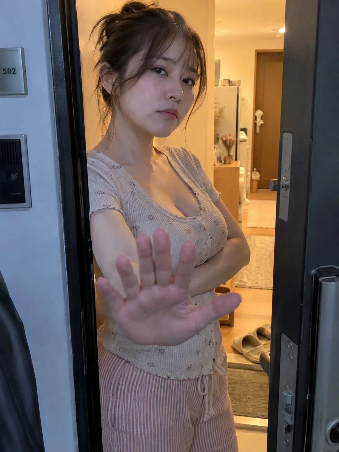 A young woman leaning against a door frame pouting at the camera in cozy loungewear, generated with 通用 / 未注明