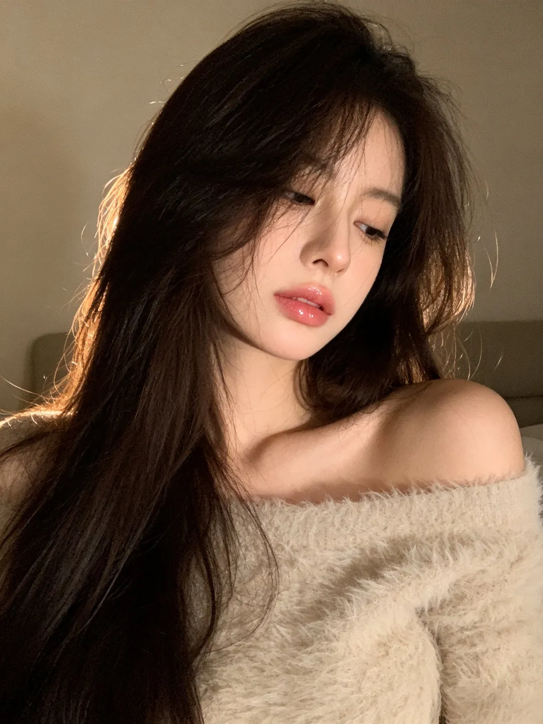 Young East Asian woman wearing an off-shoulder fuzzy sweater with long dark hair looking aside, generated with 通用 / 未注明